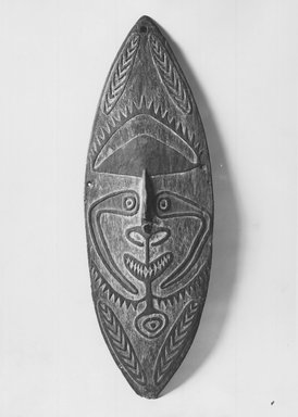 Elema. <em>Shield  with Face Motif</em>, late 19th-early 20th century. Wood, pigment, 45 x 15 in.  (114.3 x 38.1 cm). Brooklyn Museum, Brooklyn Museum Collection, X617. Creative Commons-BY (Photo: Brooklyn Museum, CUR.x617_print_front_bw.jpg)
