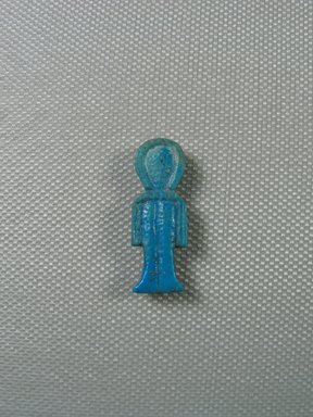  <em>Isis-knot Amulet</em>, 664–332 B.C.E. Faience, 1 3/16 x 7/16 in. (3 x 1.1 cm). Brooklyn Museum, Gift of Evangeline Wilbour Blashfield, Theodora Wilbour, and Victor Wilbour honoring the wishes of their mother, Charlotte Beebe Wilbour, as a memorial to their father Charles Edwin Wilbour, 16.580.67. Creative Commons-BY (Photo: Brooklyn Museum, CUR_16.580.67_view01.jpg)
