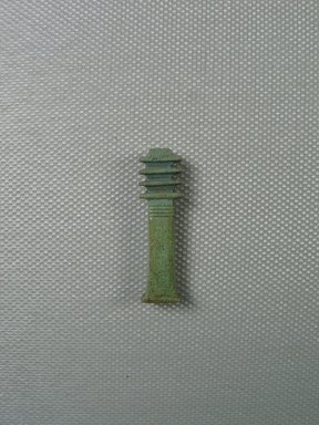  <em>Djed-pillar Amulet</em>, 664–332 B.C.E. Faience, 1 5/16 x 3/8 x 1/4 in. (3.4 x 1 x 0.6 cm). Brooklyn Museum, Charles Edwin Wilbour Fund, 37.1277E. Creative Commons-BY (Photo: Brooklyn Museum, CUR_37.1277E_view01.jpg)