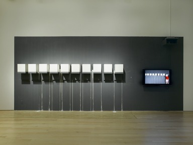 Kate Gilmore (American, born 1975). <em>Blood from a Stone</em>, 2009. (a) Single-channel video, color, sound, 8 minutes 9 seconds; (b) plaster, wood, paint
, (b) ten blocks, each: 12 x 12 x 12 in. (30.5 x 30.5 x 30.5 cm). Brooklyn Museum, (a) Gift of the Council for Feminist Art and gift of Katherine Ordway, by exchange (b) Gift of Robert D. Bielecki, 2010.16a-b. © artist or artist's estate (Photo: Brooklyn Museum, DIG_E2009_Reflections_on_the_Electric_Mirror_10_PS2.jpg)