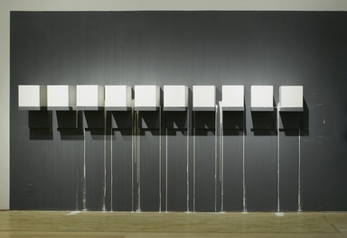 Kate Gilmore (American, born 1975). <em>Blood from a Stone</em>, 2009. (a) Single-channel video, color, sound, 8 minutes 9 seconds; (b) plaster, wood, paint
, (b) ten blocks, each: 12 x 12 x 12 in. (30.5 x 30.5 x 30.5 cm). Brooklyn Museum, (a) Gift of the Council for Feminist Art and gift of Katherine Ordway, by exchange (b) Gift of Robert D. Bielecki, 2010.16a-b. © artist or artist's estate (Photo: Brooklyn Museum, DIG_E2009_Reflections_on_the_Electric_Mirror_11_PS2.jpg)