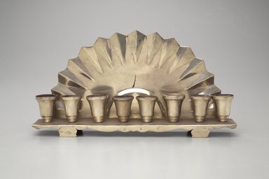 Jewish. <em>Hanukkah Menorah</em>, late 19th-early 20th century. Silver-plated metal, 4 3/4 x 9 x 1 5/8in. (12.1 x 22.9 x 4.1cm). Assigned to the Brooklyn Museum by Jewish Cultural Reconstruction, Inc., L50.26.11. Creative Commons-BY (Photo: Brooklyn Museum, L50.26.11.jpg)