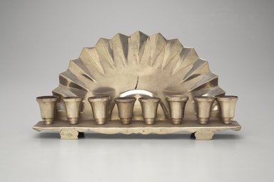 Jewish. <em>Hanukkah Menorah</em>, late 19th–early 20th century. Silver-plated metal, 4 3/4 x 9 x 1 5/8in. (12.1 x 22.9 x 4.1cm). Assigned to the Brooklyn Museum by Jewish Cultural Reconstruction, Inc., L50.26.11. Creative Commons-BY (Photo: Brooklyn Museum, L50.26.11.jpg)