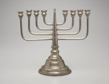 Jewish. <em>Hanukkah Menorah</em>, late 19th-early 20th century. Silver-plated metal, 10 1/2 x 11 1/2 x 5 3/8 in. (26.7 x 29.2 x 13.7cm). Assigned to the Brooklyn Museum by Jewish Cultural Reconstruction, Inc., L50.26.13. Creative Commons-BY (Photo: Brooklyn Museum, L50.26.13.jpg)