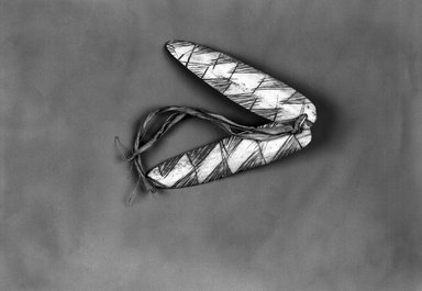 Native Alaskan. <em>Two Arrow-shaped Fish Lures attached by leather strips</em>, late 19th-early 20th century. Bone, hide, pigment or ink, each lure: 3 3/4 x 1 in. or (9.5 cm). Brooklyn Museum, Brooklyn Museum Collection, X705.6. Creative Commons-BY (Photo: Brooklyn Museum, X705.6_bw.jpg)
