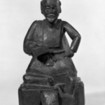 Folk Sculpture (A Man Seated On a Chess Board)