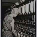 [Untitled] (Elderly Woman at Bank of Thread Cylinders)