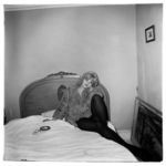 Girl in a Coat Lying on Her Bed, N.Y.C.