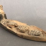 Seated Figurine in Canoe with Three Turtles
