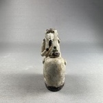 Ape Holding a Vessel