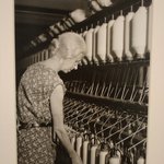 [Untitled] (Elderly Woman at Bank of Thread Cylinders)