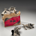 Sculpture of charcoal box filled with newspaper