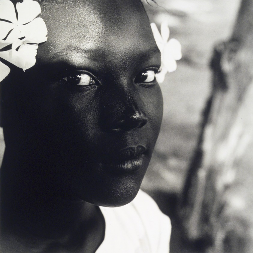 Tony Gleaton (American, 1948-2015). <em>Black Girl, White Flower, Belize, Central America</em>, 1992. Gelatin silver photograph, image: 15 3/4 x 14 3/4 in. (40 x 37.5 cm). Brooklyn Museum, Gift of Helen Griffith in memory of Seymour Griffith, 1997.134. © artist or artist's estate (Photo: Brooklyn Museum, 1997.134_transp5713.jpg)