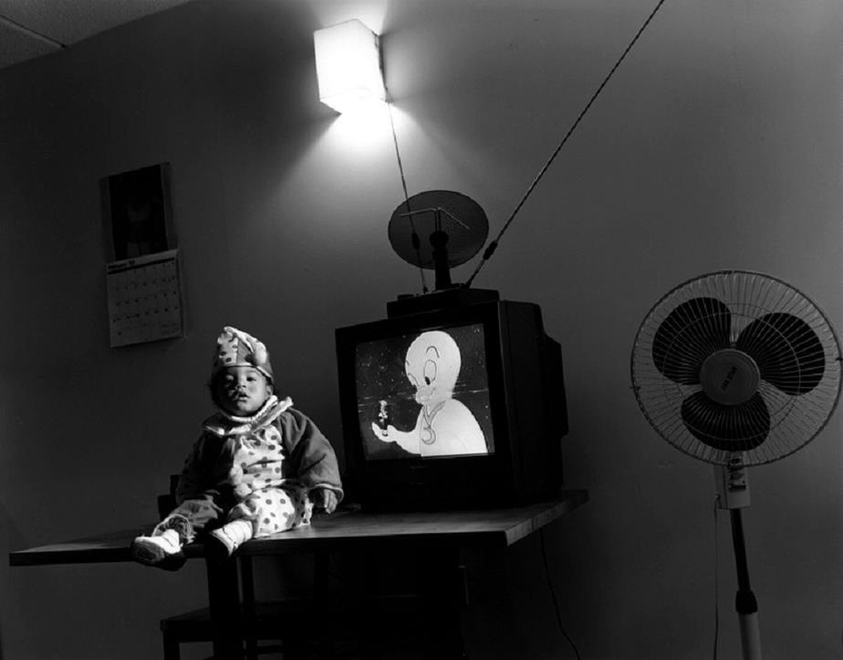 Mary Ellen Mark (American, 1940–2015). <em>Little Clown and TV, Help Portraits</em>, 1993; printed later. Gelatin silver print, Sheet: 16 × 19 13/16 in. (40.6 × 50.3 cm). Brooklyn Museum, Gift of Howard Greenberg, 2019.50.5. © artist or artist's estate (Photo: Image courtesy of the estate of Mary Ellen Mark, CUR.2019.50.5_MaryEllenMarkEstate_photograph.jpg)