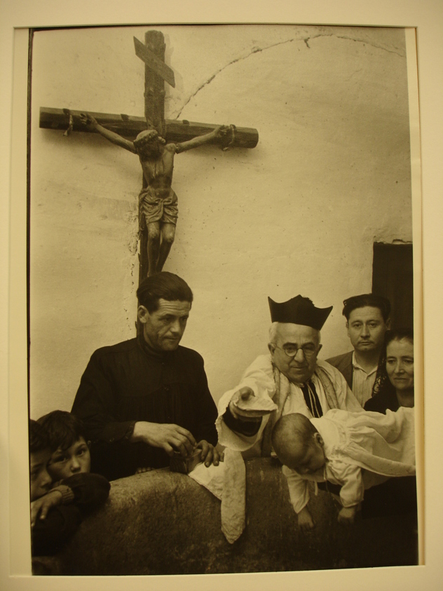 W. Eugene Smith (American, 1918-1978). <em>[Untitled] (Christening Scene with Crucifix in Background)</em>, 1950. Gelatin silver print, Sheet: 14 x 11 in. (35.6 x 27.9 cm). Brooklyn Museum, Gift of Philip Goutell, 87.245.44. © artist or artist's estate (Photo: Brooklyn Museum, CUR.87.245.44.jpg)